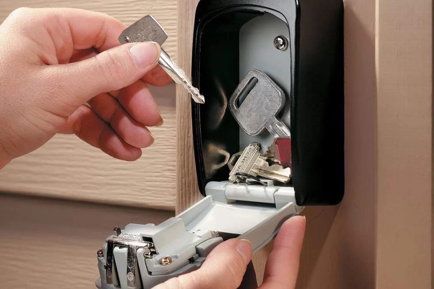 a person opening a key box